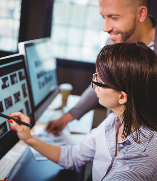 female-photo-editor-discussing-over-computer-with-2023